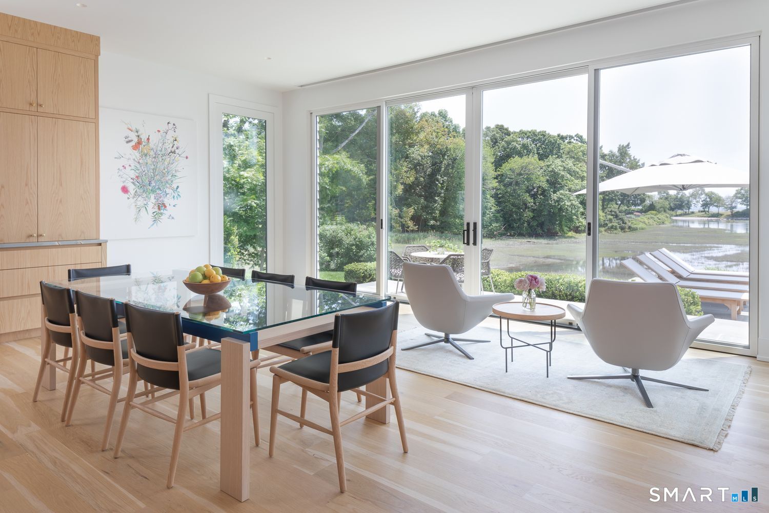 19 Beachside Common Westport, CT 06880 - Photo 10 of 40 a dining room with furniture a rug and wooden floor