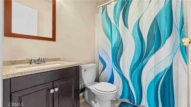 a bathroom with a toilet sink and a mirror