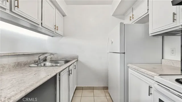 a kitchen with stainless steel appliances granite countertop a sink and refrigerator