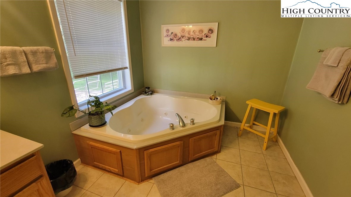 412 Mulberry Mountain Road Boone, NC 28607 - Photo 11 of 31 a bathroom with a tub and a window