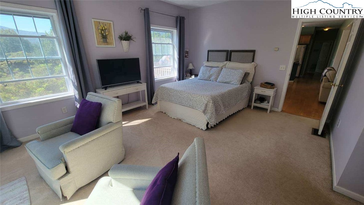 412 Mulberry Mountain Road Boone, NC 28607 - Photo 10 of 31 a bedroom with a bed and a flat screen tv
