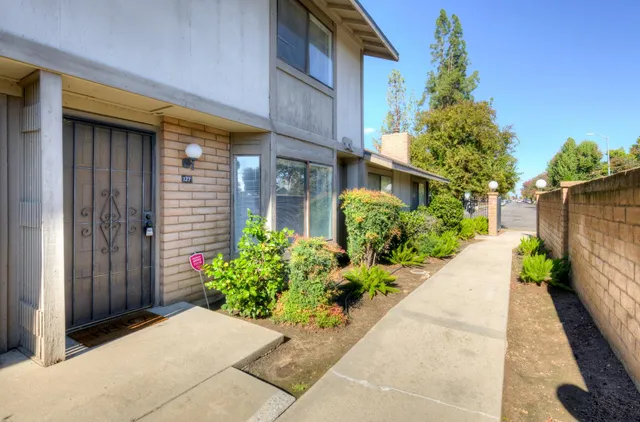 a view of a house with potted plants