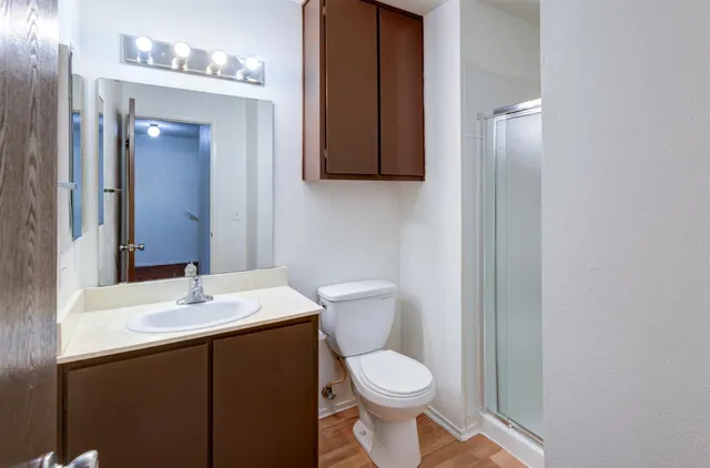 a bathroom with a sink a toilet and mirror