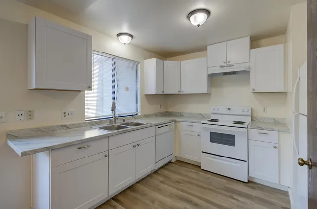 a kitchen with a sink stove and cabinets
