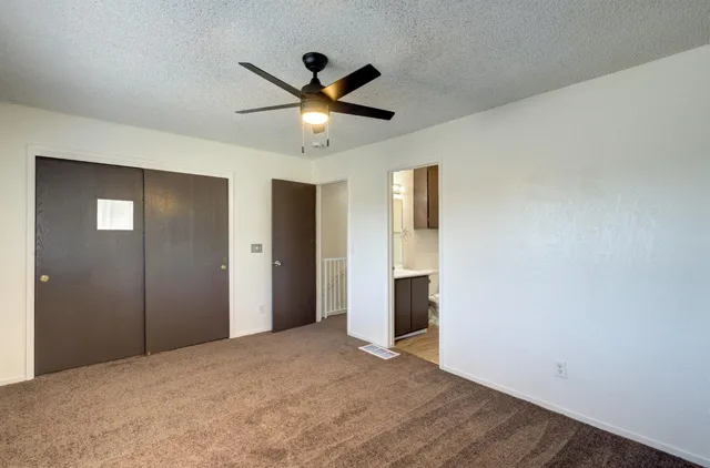 a view of a big room with wooden floor and windows in a room