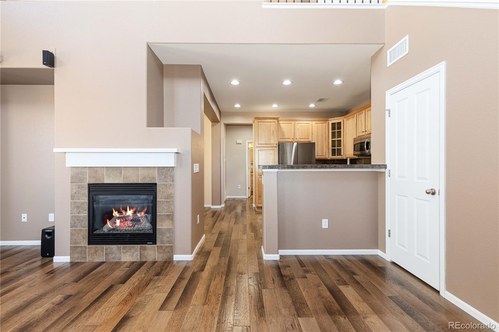 3301 Cascina Circle, Unit C Highlands Ranch, CO 80126 - Photo 11 of 40 a view of a kitchen with a fireplace and wooden floor