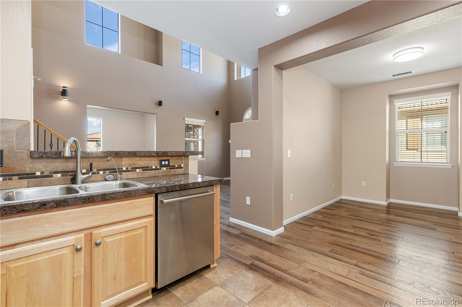 3301 Cascina Circle, Unit C Highlands Ranch, CO 80126 - Photo 13 of 40 a kitchen with a sink cabinets and wooden floor