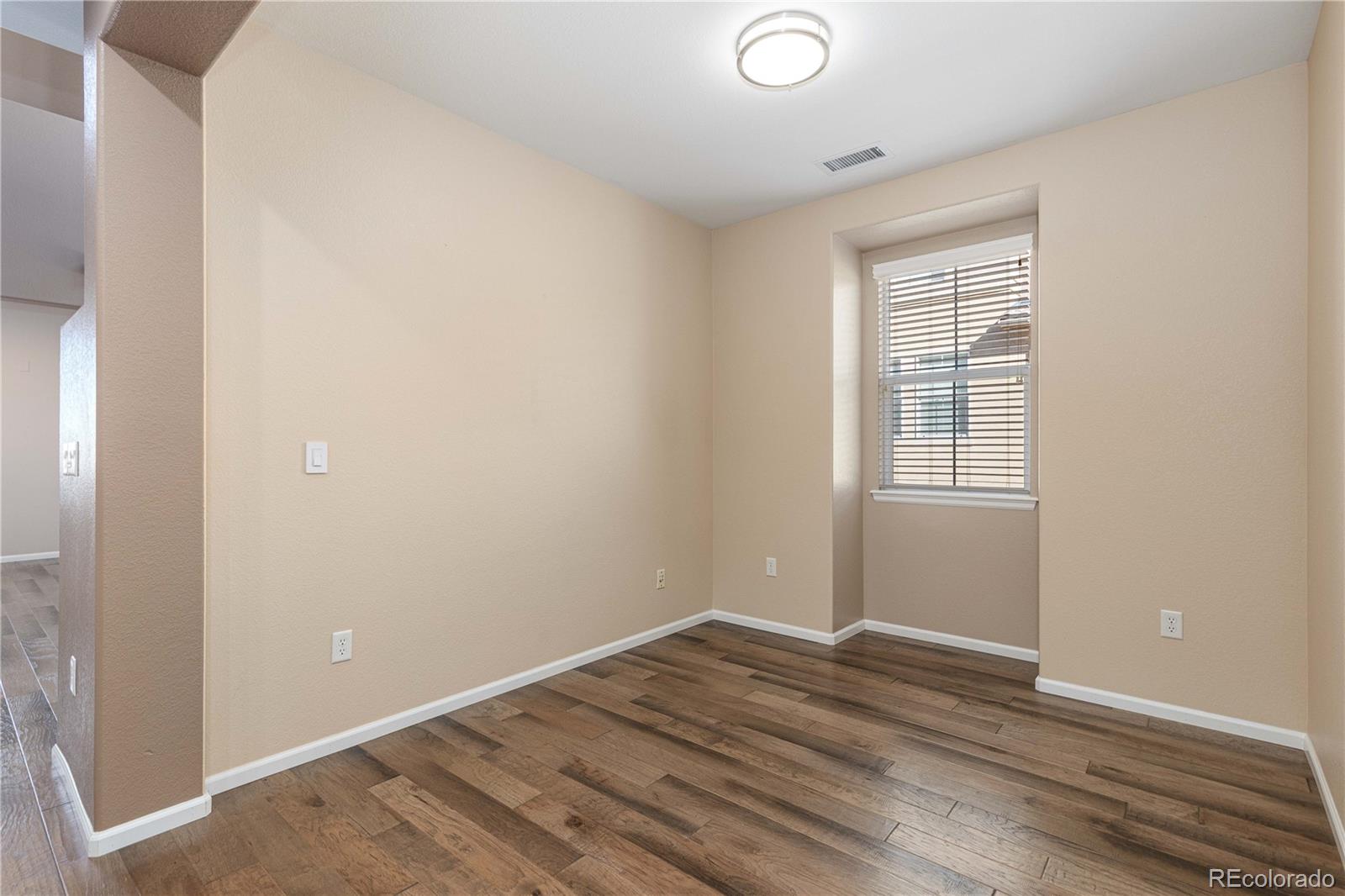 3301 Cascina Circle, Unit C Highlands Ranch, CO 80126 - Photo 14 of 40 an empty room with wooden floor and windows