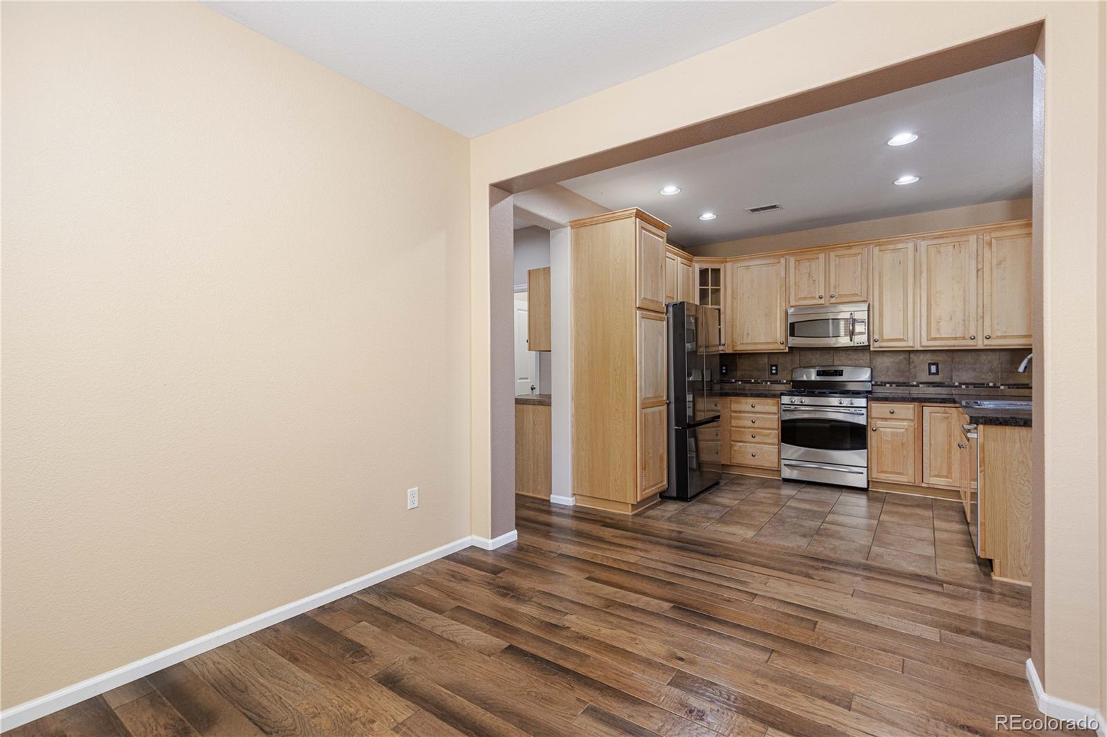 3301 Cascina Circle, Unit C Highlands Ranch, CO 80126 - Photo 17 of 40 a view of kitchen view wooden floor and stainless steel appliances