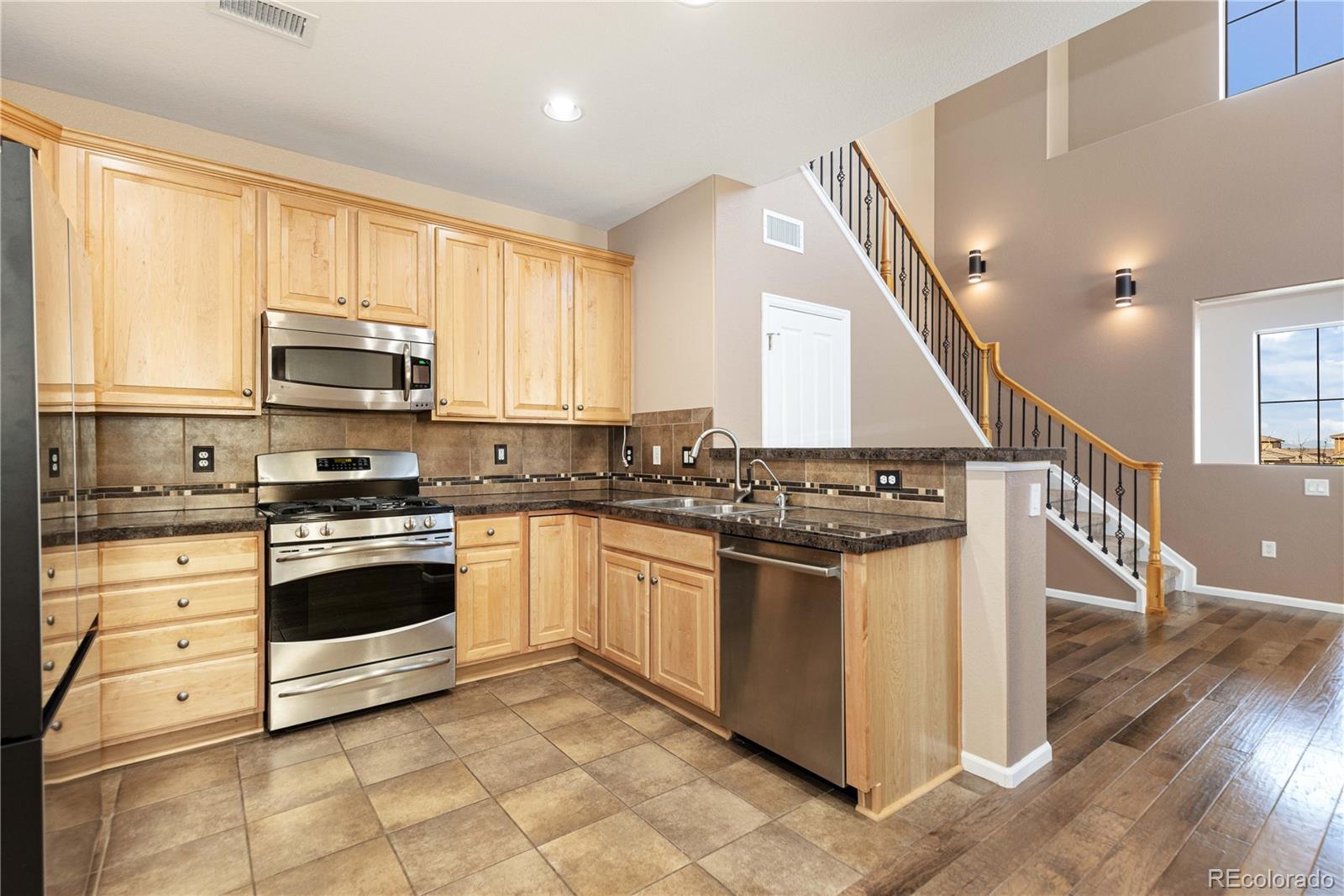 3301 Cascina Circle, Unit C Highlands Ranch, CO 80126 - Photo 18 of 40 a kitchen with stainless steel appliances granite countertop a stove and a sink
