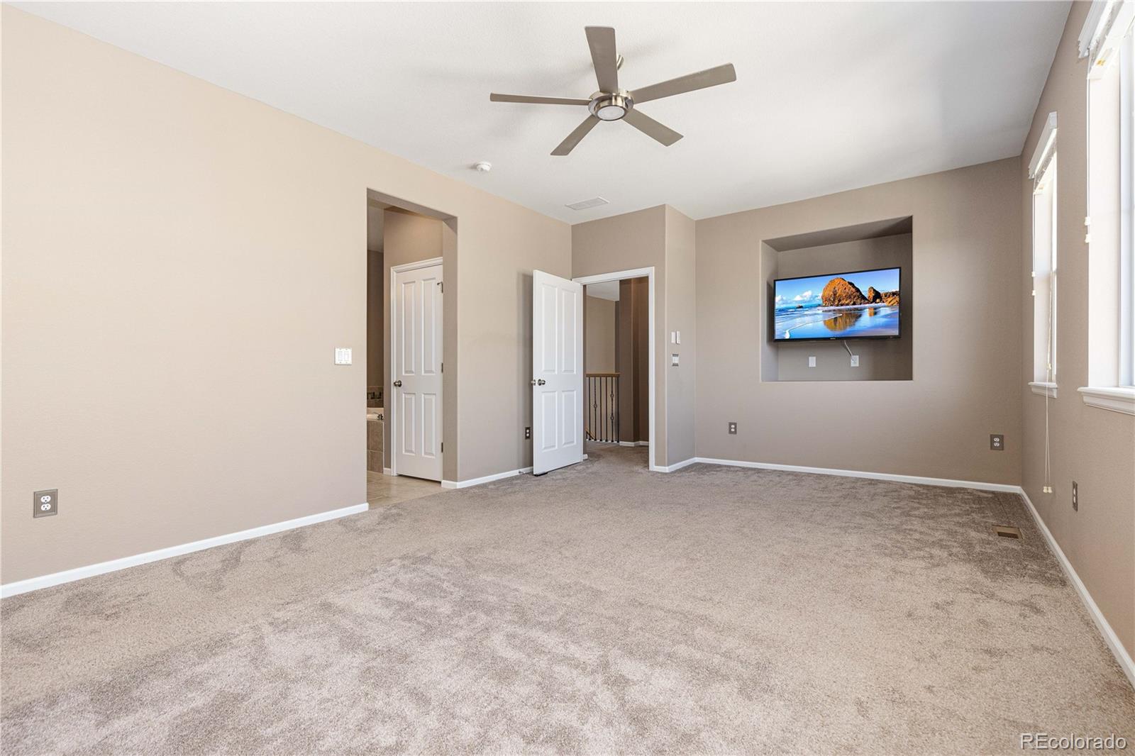 3301 Cascina Circle, Unit C Highlands Ranch, CO 80126 - Photo 27 of 40 an empty room with windows and fan