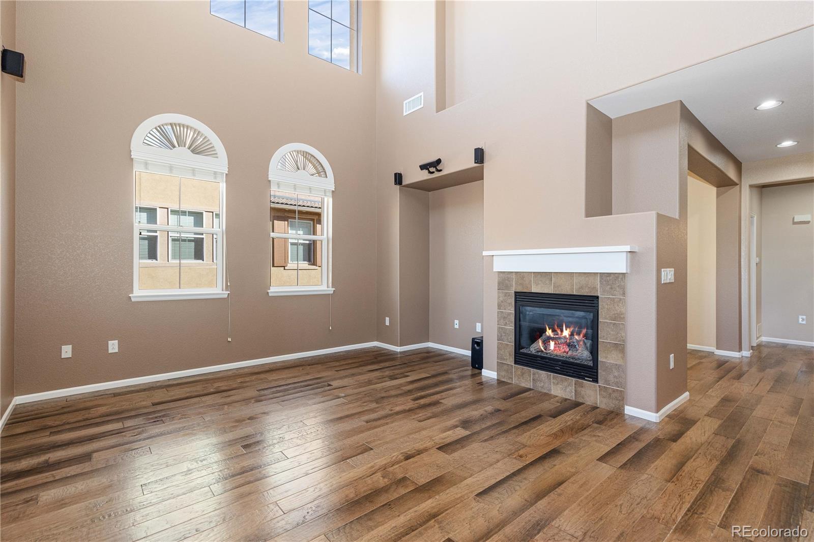 3301 Cascina Circle, Unit C Highlands Ranch, CO 80126 - Photo 5 of 40 a view of livingroom with fireplace wooden floor and window