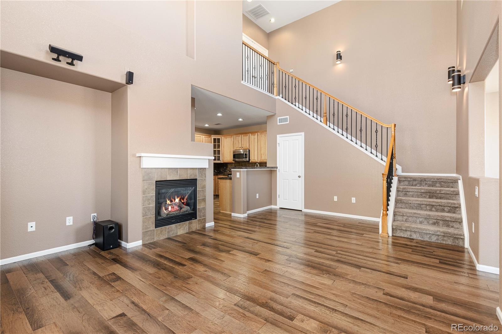 3301 Cascina Circle, Unit C Highlands Ranch, CO 80126 - Photo 7 of 40 a view of a livingroom with wooden floor and a fireplace