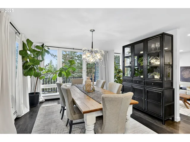 a dining room with furniture large windows and a chandelier