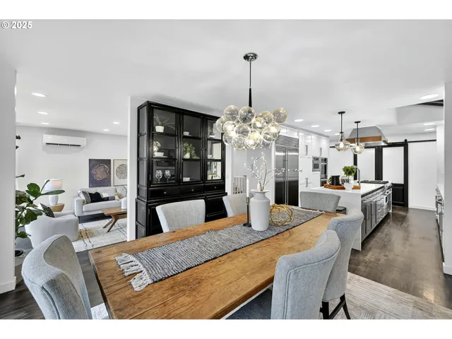 a living room with furniture chandelier and kitchen view