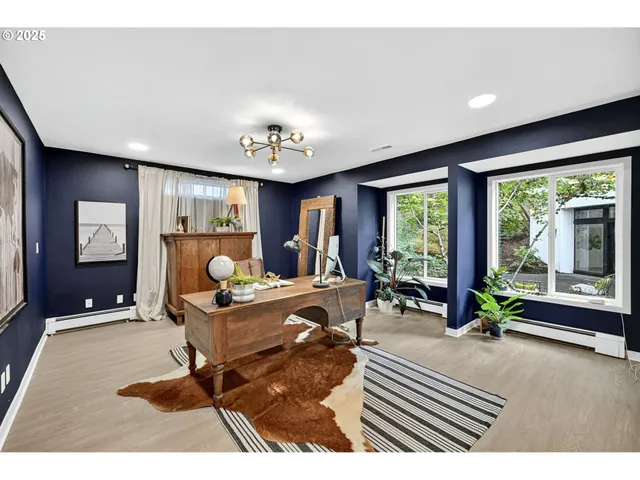 a living room with furniture and large windows