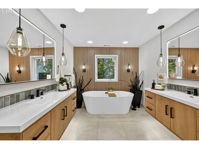 a bathroom with a tub sink and mirror