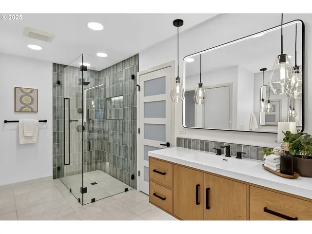 a bathroom with a shower sink and mirror