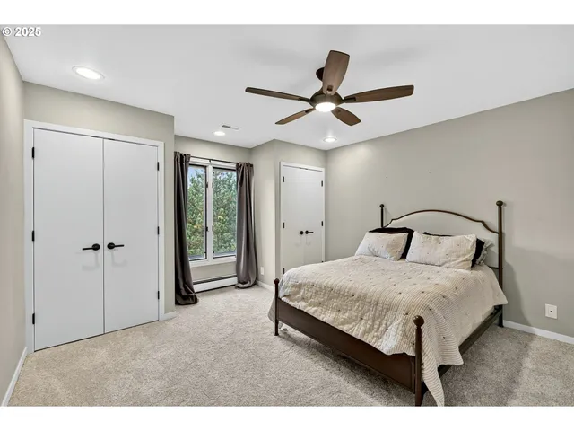a bedroom with a bed and a ceiling fan