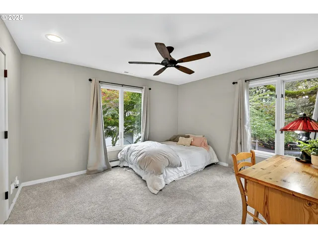 a bed room with a bed and a large window