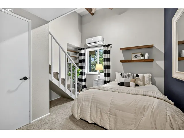 a bedroom with a bed next to a large window