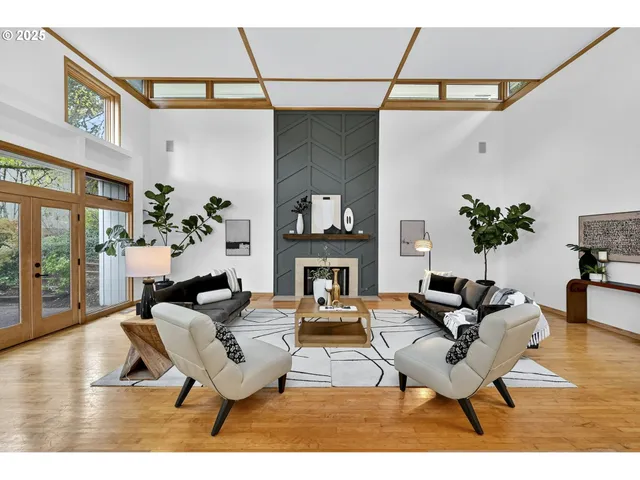 a living room with furniture a chandelier and a potted plant