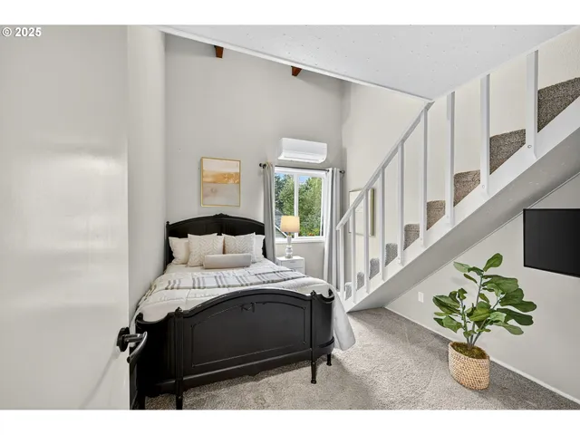 a bedroom with a bed table and a potted plant