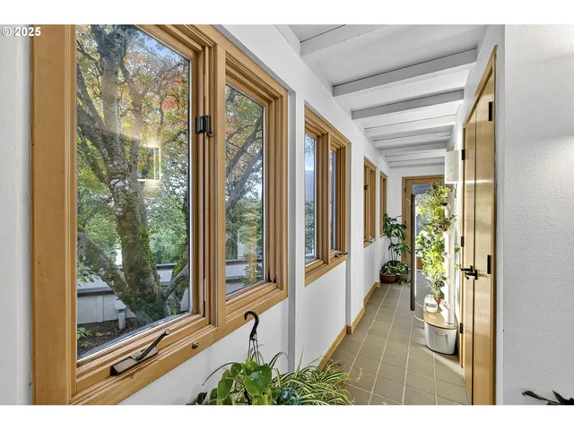 a view of an entryway with wooden floor and garden