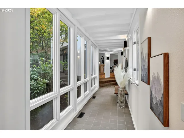 a view of a living room hardwood floor and a large window