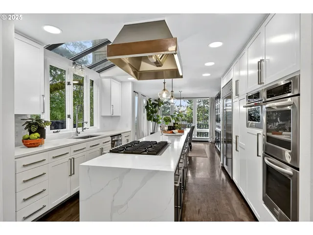 a kitchen with a sink stainless steel appliances and cabinets