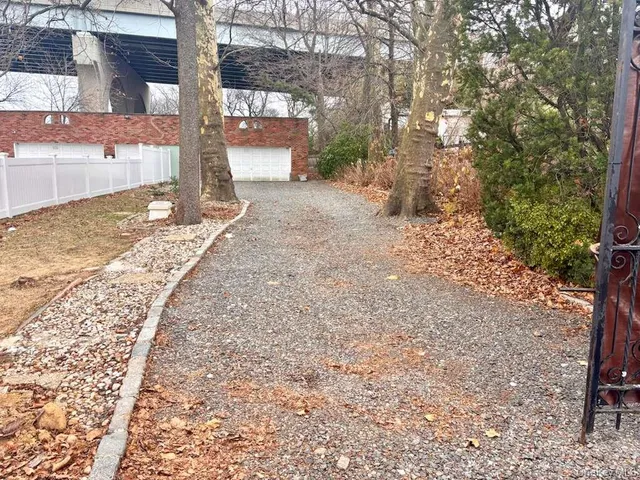 a view of a backyard with large tree