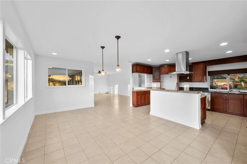 5251 Hamer Lane Placentia, CA 92870 - Photo 7 of 38 a view of kitchen with kitchen island stainless steel appliances wooden floor and window