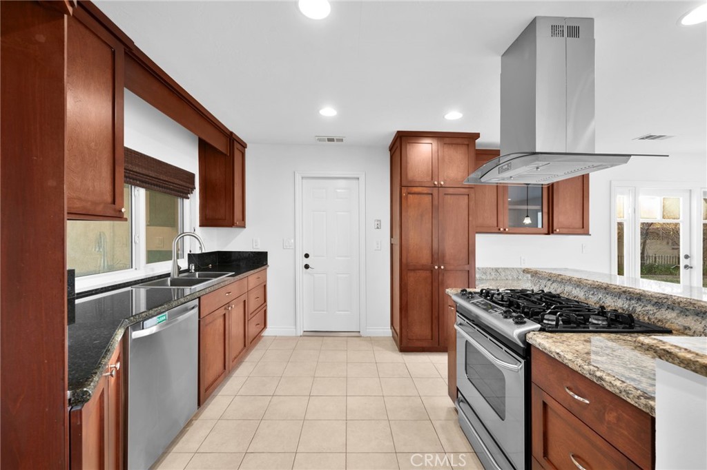 5251 Hamer Lane Placentia, CA 92870 - Photo 9 of 38 a kitchen with stainless steel appliances granite countertop a stove a sink and a refrigerator