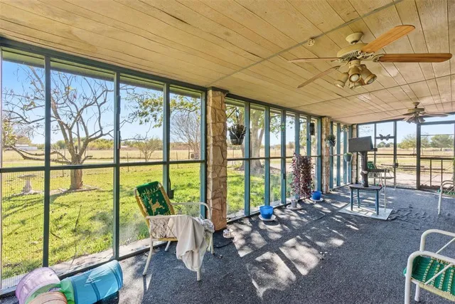 a living room with furniture and large windows