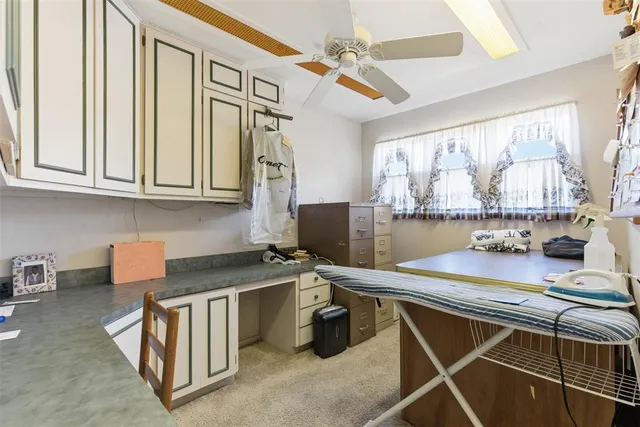 a room with stainless steel appliances kitchen island granite countertop furniture and a window