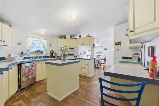 a kitchen with cabinets and wooden floor