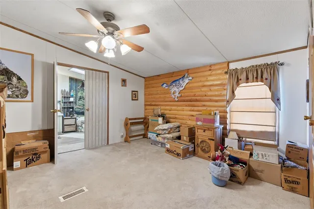 a view of a livingroom with furniture and a ceiling fan