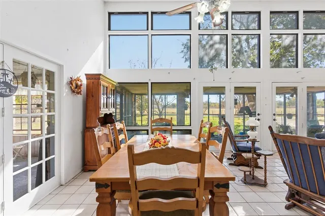 a view of a dining room with furniture large windows and wooden floor