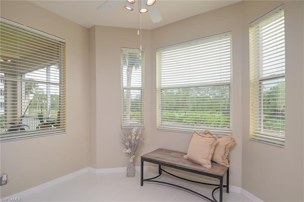 8670 Cedar Hammock Circle, Unit 223 Naples, FL 34112 - Photo 12 of 27 a living room with furniture and a window