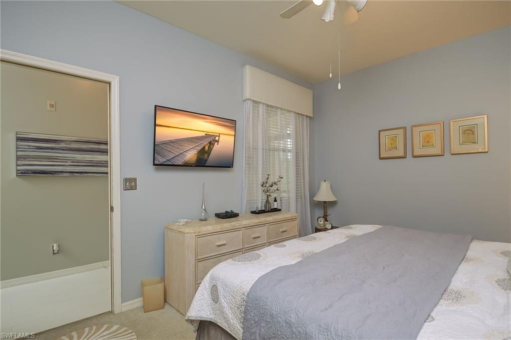 8670 Cedar Hammock Circle, Unit 223 Naples, FL 34112 - Photo 15 of 27 a bedroom with a bed and a flat screen tv