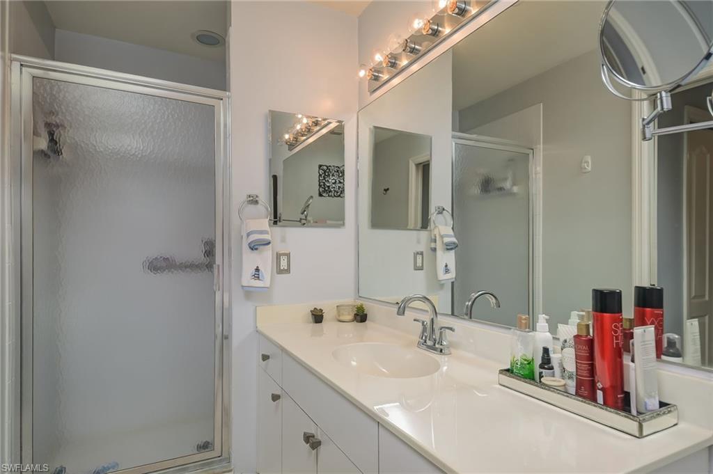 8670 Cedar Hammock Circle, Unit 223 Naples, FL 34112 - Photo 16 of 27 a bathroom with a sink double vanity and shower