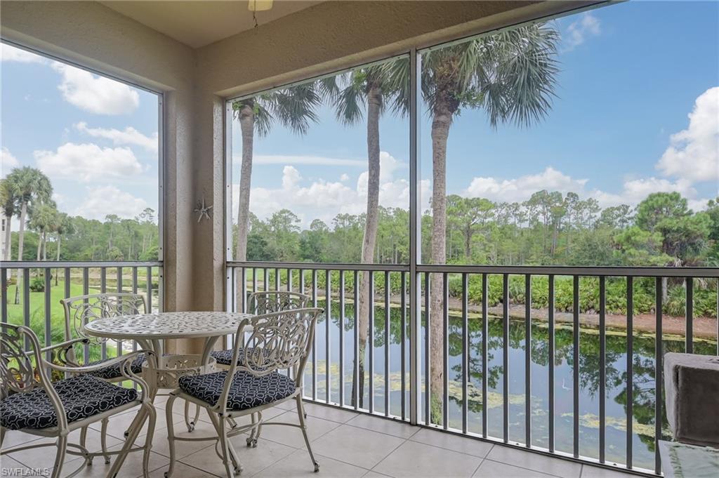 8670 Cedar Hammock Circle, Unit 223 Naples, FL 34112 - Photo 21 of 27 a view of a balcony with furniture and floor to ceiling window