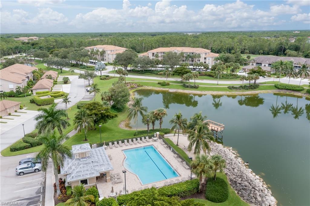 8670 Cedar Hammock Circle, Unit 223 Naples, FL 34112 - Photo 23 of 27 an aerial view of house with yard and lake view