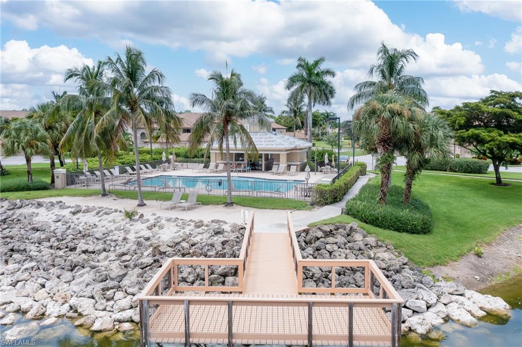 8670 Cedar Hammock Circle, Unit 223 Naples, FL 34112 - Photo 24 of 27 a view of a swimming pool with a garden