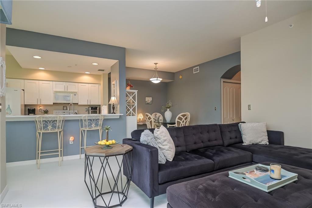 8670 Cedar Hammock Circle, Unit 223 Naples, FL 34112 - Photo 4 of 27 a living room with furniture and kitchen view