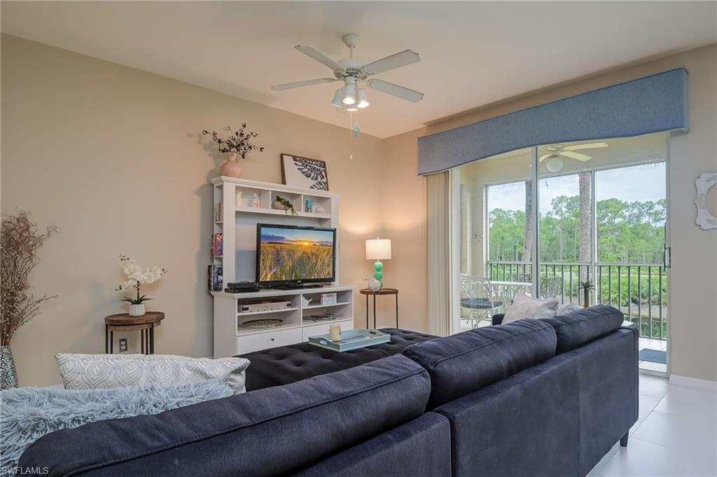 8670 Cedar Hammock Circle, Unit 223 Naples, FL 34112 - Photo 5 of 27 a living room with furniture and a flat screen tv