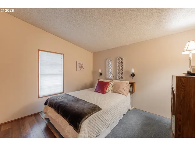 a bedroom with a bed and a night stand