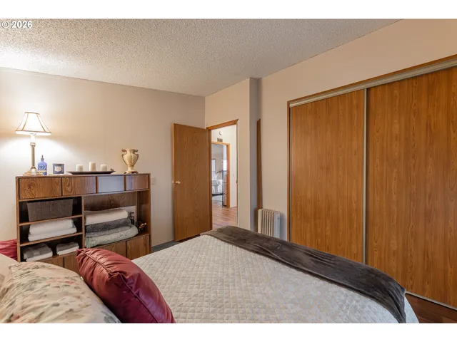 a bedroom with a bed and a chair