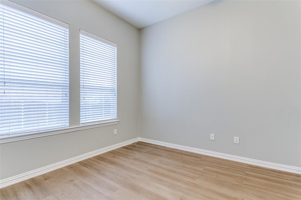 3725 Vienna Street Irving, TX 75038 - Photo 11 of 25 an empty room with wooden floor and windows