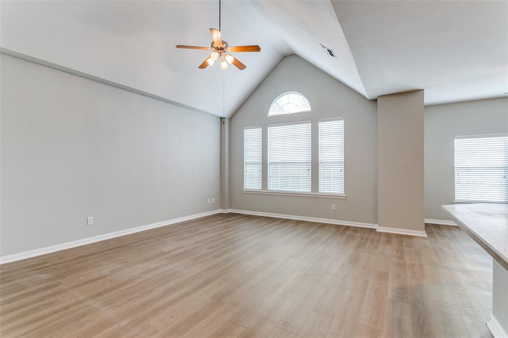 3725 Vienna Street Irving, TX 75038 - Photo 13 of 25 an empty room with wooden floor and windows